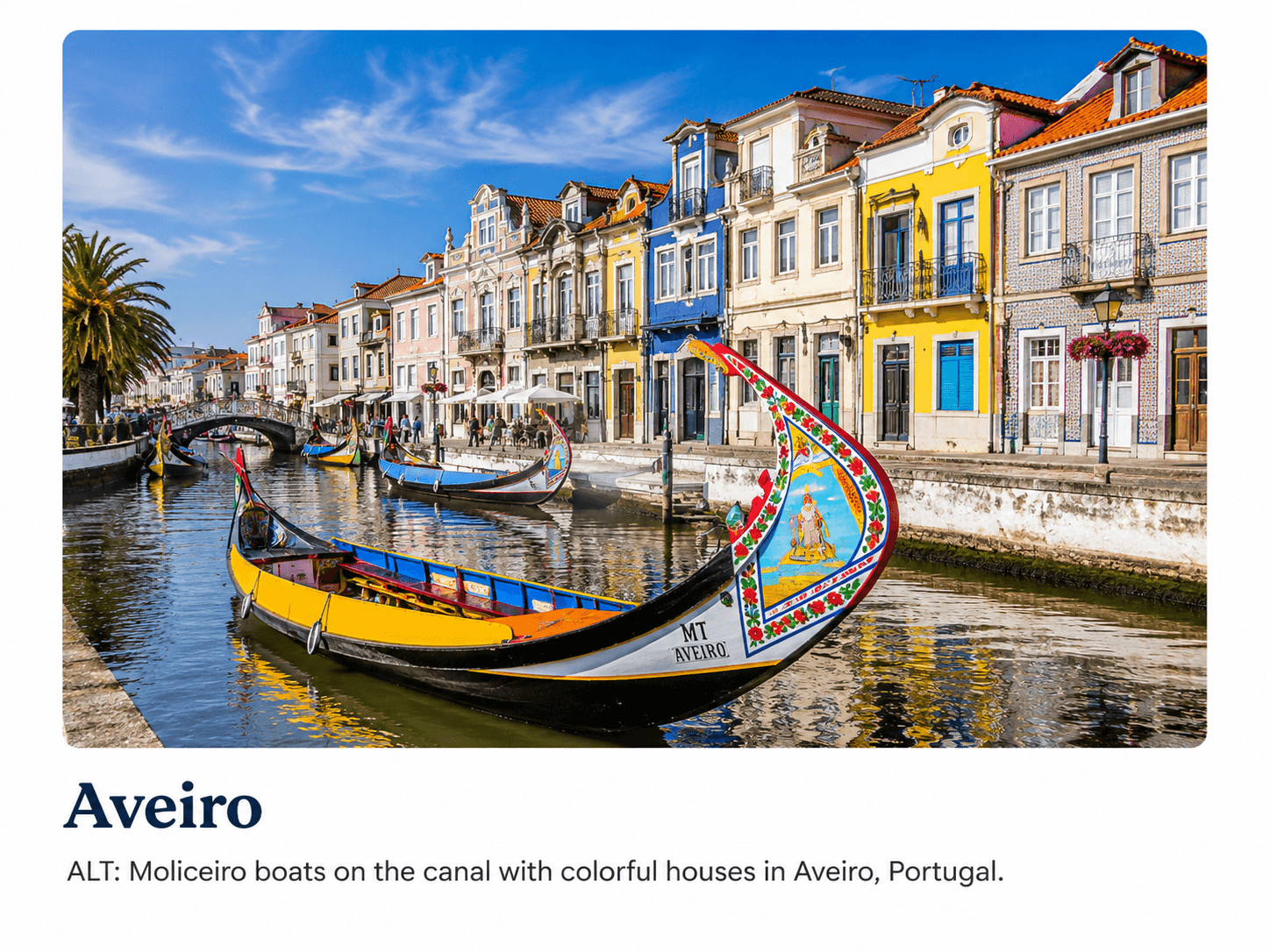 Moliceiro boats on the canal with colourful Art Nouveau houses in Aveiro, Portugal.